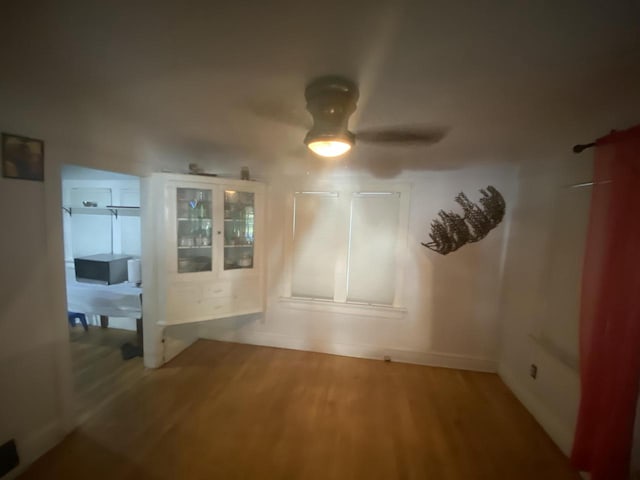 empty room with wood-type flooring and ceiling fan