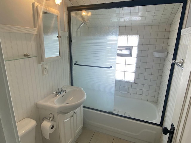 full bathroom with tile patterned flooring, combined bath / shower with glass door, vanity, and toilet