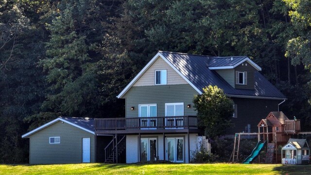 W9037 Ridgeview Trl, New Lisbon, WI 53950 - back of house with a yard, a wooden deck, stairway, and a playground