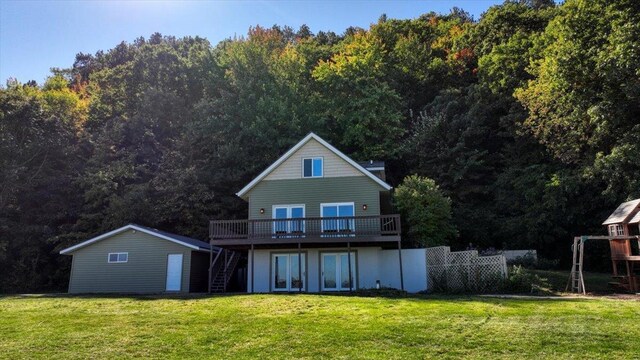 W9037 Ridgeview Trl, New Lisbon, WI 53950 - rear view of property featuring stairs, a wooden deck, a lawn, and a wooded view