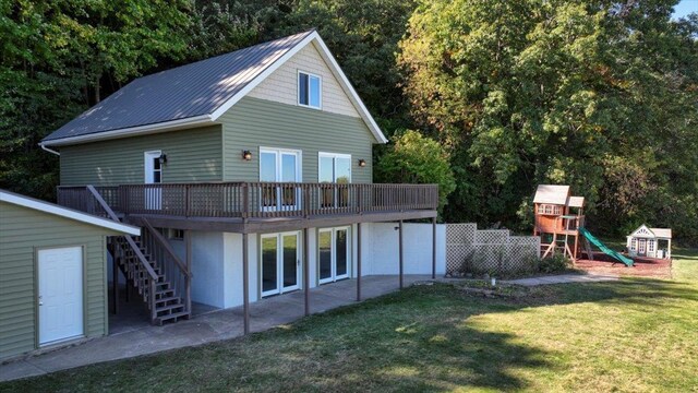 W9037 Ridgeview Trl, New Lisbon, WI 53950 - rear view of property featuring a playground, a lawn, stairway, metal roof, and a deck