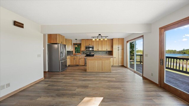 W9037 Ridgeview Trl, New Lisbon, WI 53950 - kitchen with appliances with stainless steel finishes, baseboards, tasteful backsplash, and dark wood finished floors