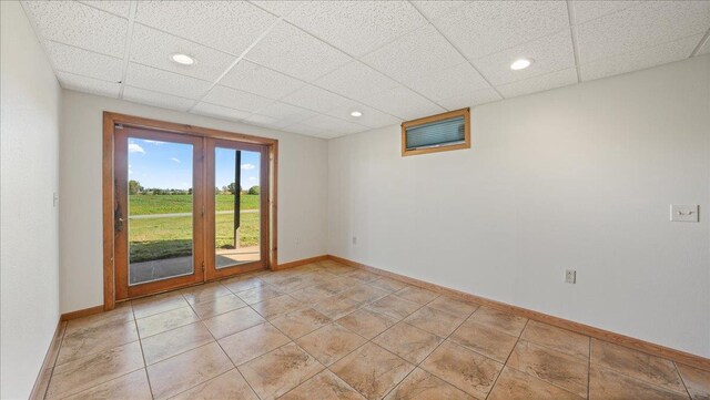W9037 Ridgeview Trl, New Lisbon, WI 53950 - spare room featuring baseboards, a drop ceiling, recessed lighting, and light tile patterned floors