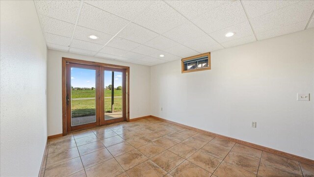W9037 Ridgeview Trl, New Lisbon, WI 53950 - unfurnished room with a drop ceiling, baseboards, recessed lighting, and light tile patterned flooring