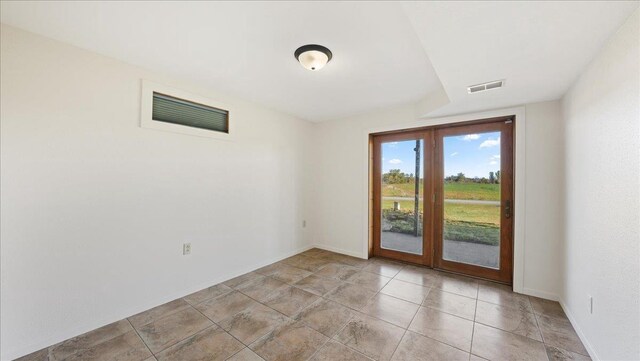 W9037 Ridgeview Trl, New Lisbon, WI 53950 - unfurnished room featuring baseboards, french doors, and light tile patterned floors