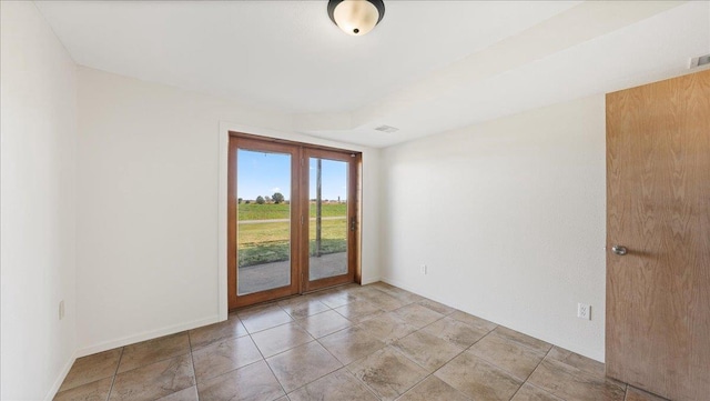 unfurnished room with french doors