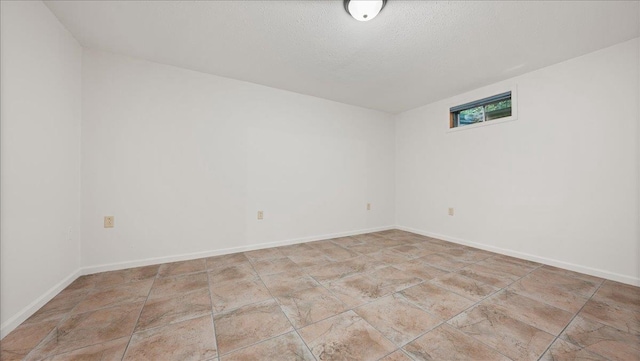 spare room with a textured ceiling