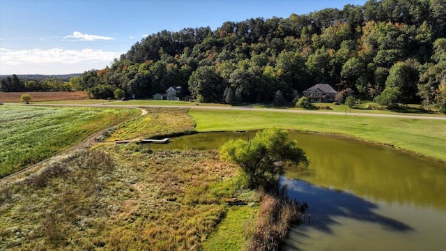 surrounding community with a water view and a yard