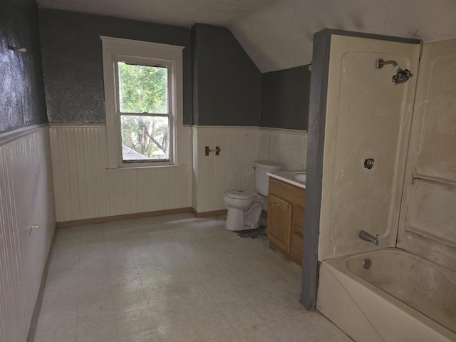 full bathroom featuring tub / shower combination, vaulted ceiling, vanity, and toilet