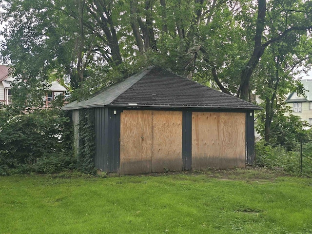 view of outbuilding with a lawn