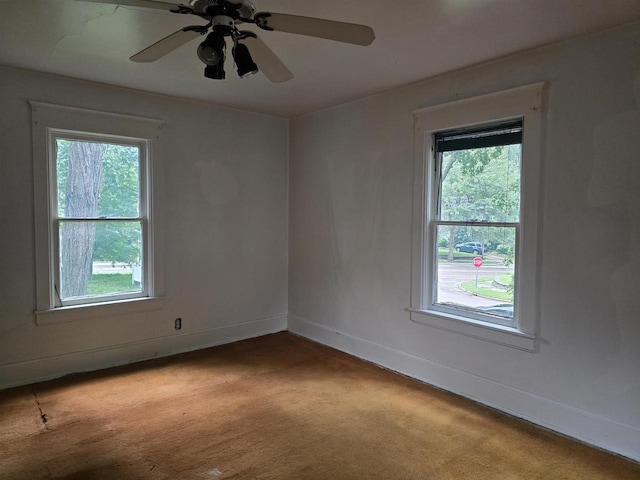 unfurnished room with light carpet, ceiling fan, and plenty of natural light