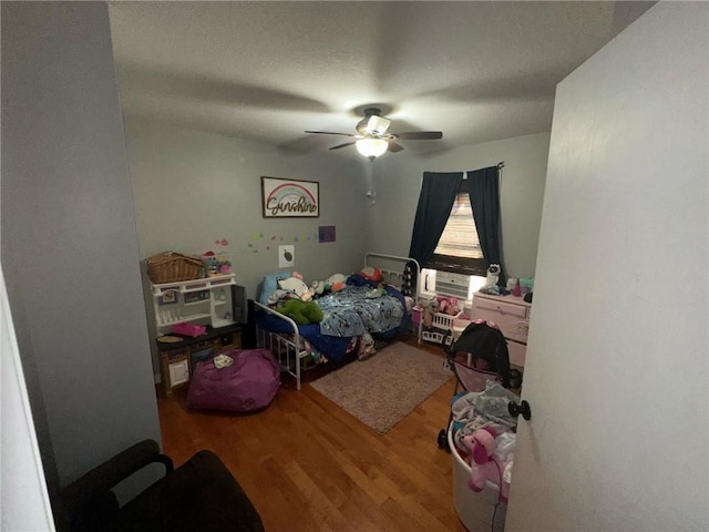 bedroom with ceiling fan and hardwood / wood-style floors