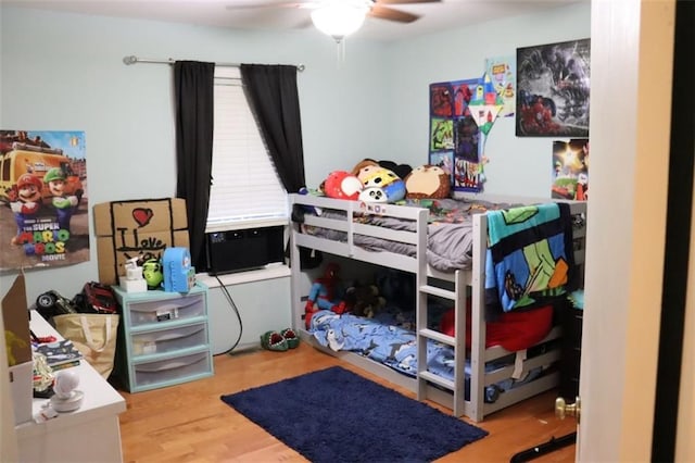 bedroom with ceiling fan and hardwood / wood-style floors