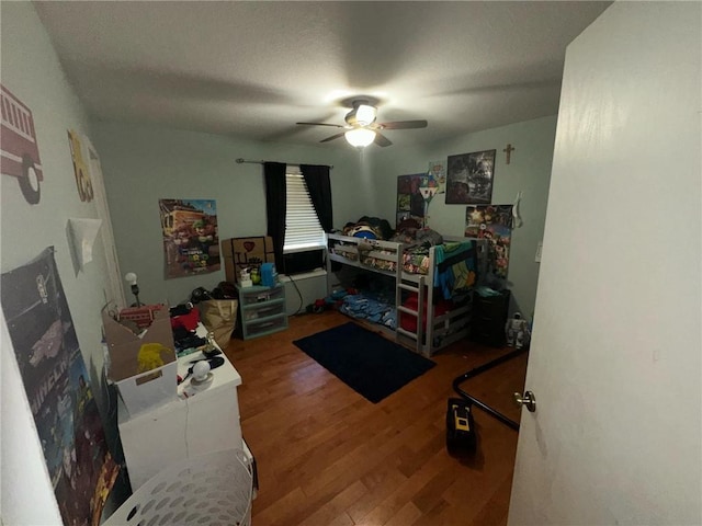 bedroom with ceiling fan and hardwood / wood-style flooring