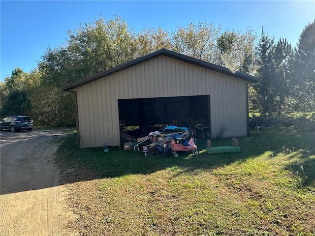 view of outbuilding featuring a lawn and a garage