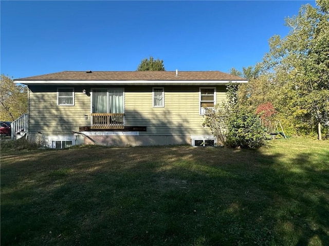 rear view of house featuring a lawn