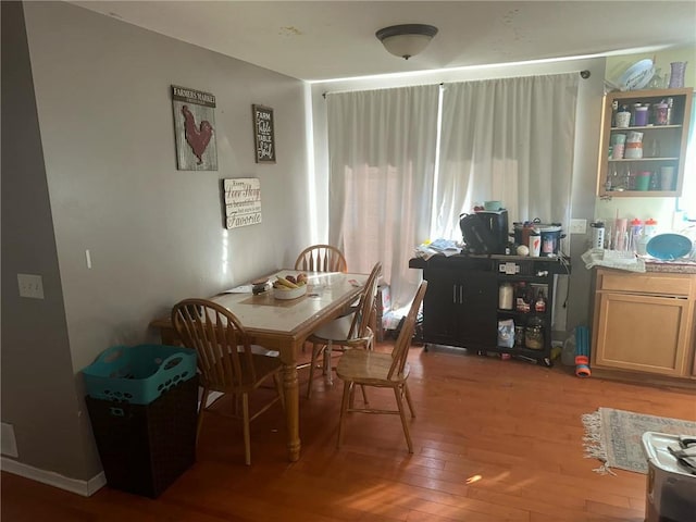 dining area with a healthy amount of sunlight and hardwood / wood-style flooring