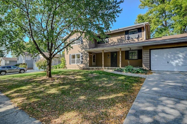 view of front of home with a front yard and a garage