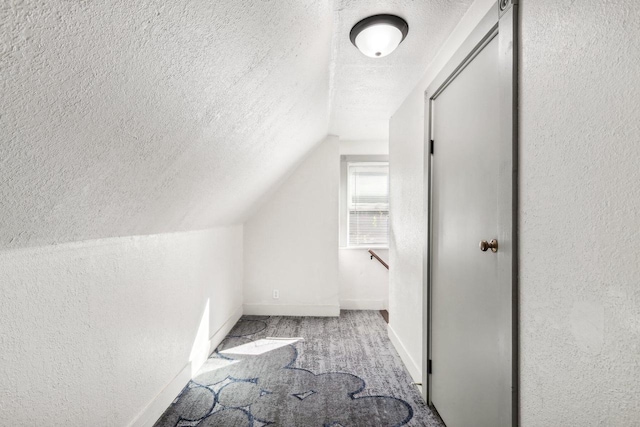 bonus room featuring lofted ceiling, light carpet, and a textured ceiling