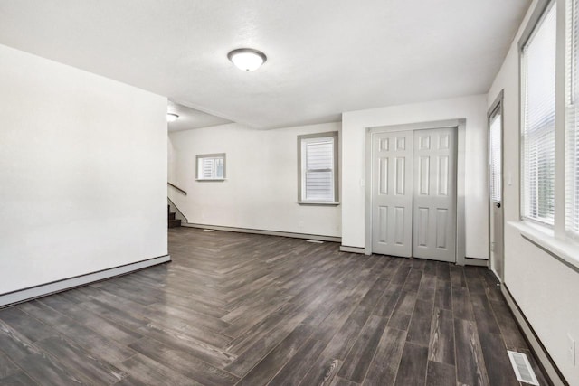 spare room featuring dark hardwood / wood-style flooring and a baseboard radiator