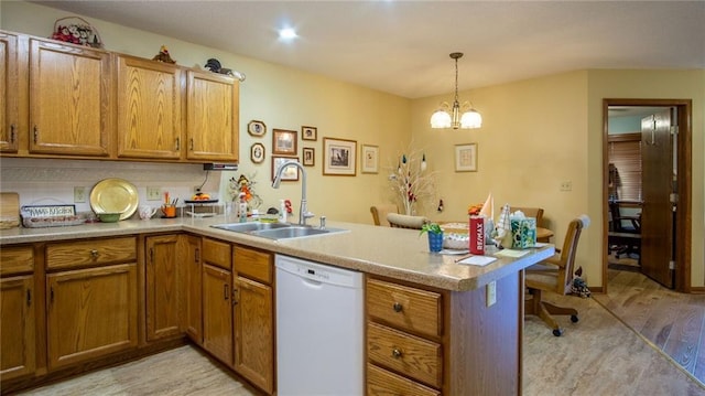 kitchen featuring sink, kitchen peninsula, hanging light fixtures, light hardwood / wood-style flooring, and white dishwasher