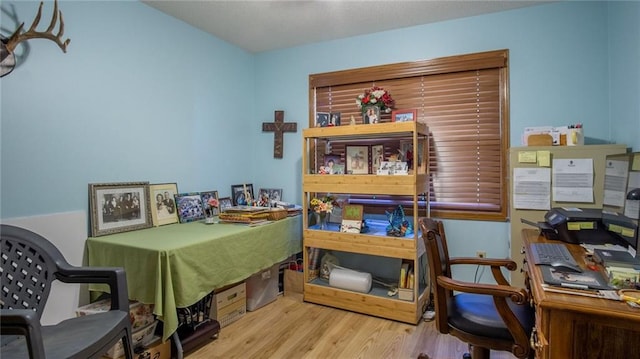 home office with light hardwood / wood-style flooring