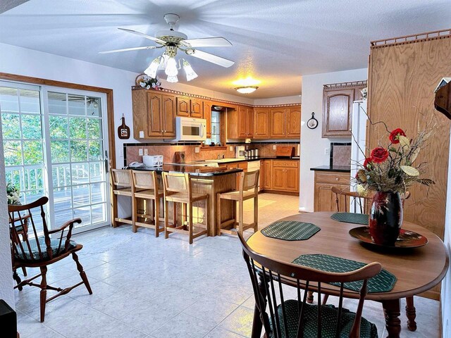 63574 Lohmann Ln, Eastman, WI 52626 - dining room with light tile patterned flooring and a ceiling fan