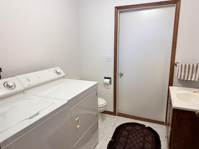 63574 Lohmann Ln, Eastman, WI 52626 - washroom with washing machine and clothes dryer and baseboards