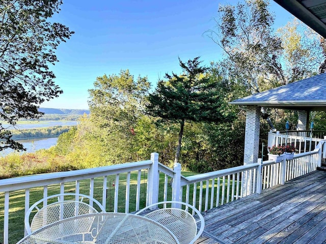 63574 Lohmann Ln, Eastman, WI 52626 - wooden deck featuring outdoor dining area, a yard, and a water view