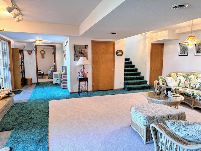 63574 Lohmann Ln, Eastman, WI 52626 - living room with carpet, stairway, and baseboards
