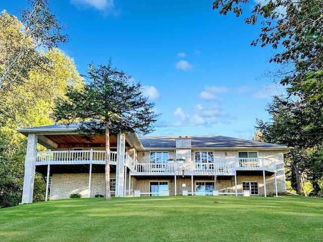63574 Lohmann Ln, Eastman, WI 52626 - rear view of property featuring a wooden deck, a yard, and ceiling fan