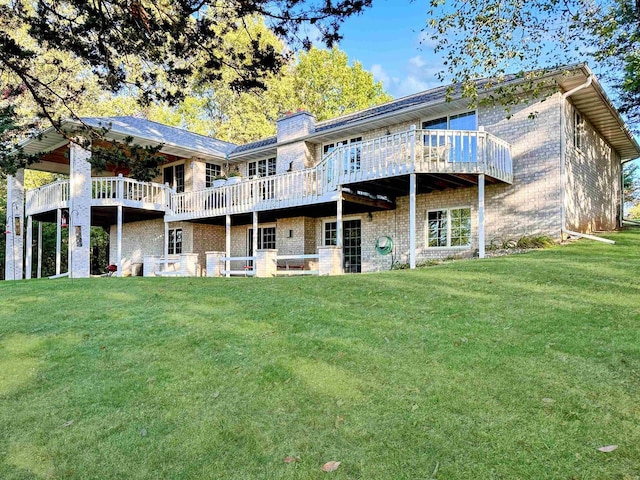 63574 Lohmann Ln, Eastman, WI 52626 - back of property featuring a yard, a deck, brick siding, and a chimney