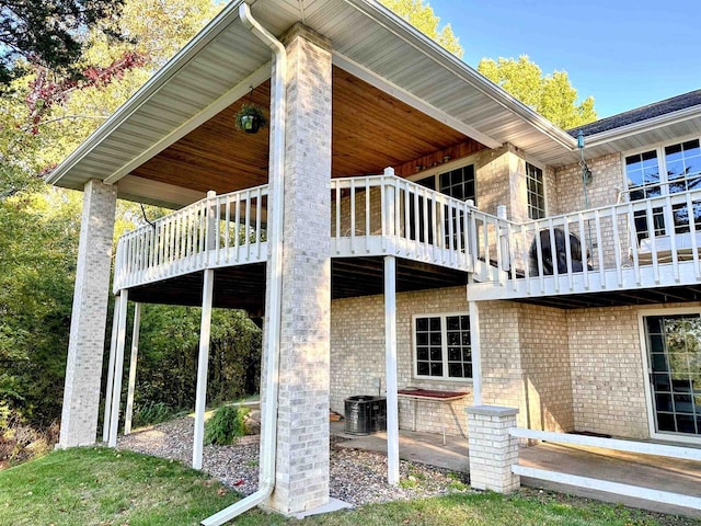 63574 Lohmann Ln, Eastman, WI 52626 - view of property exterior featuring a patio, brick siding, and central AC unit