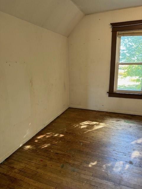 bonus room with vaulted ceiling and dark wood-type flooring