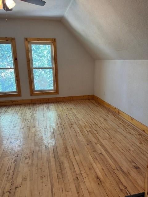 bonus room with lofted ceiling, ceiling fan, and light hardwood / wood-style flooring