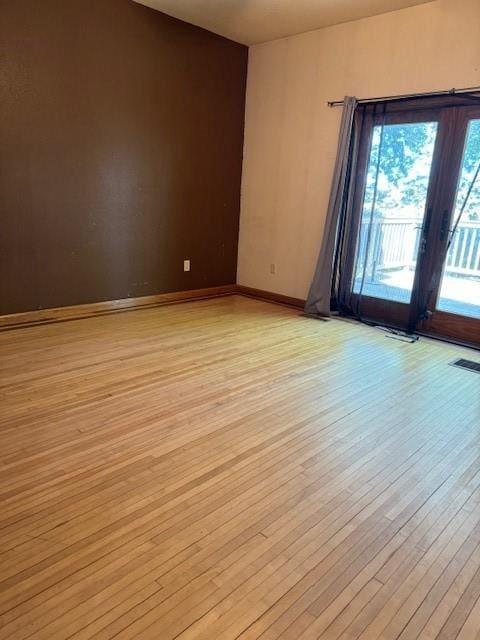 unfurnished room with light wood-type flooring