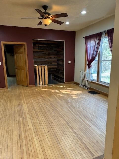 unfurnished living room featuring light hardwood / wood-style floors and ceiling fan