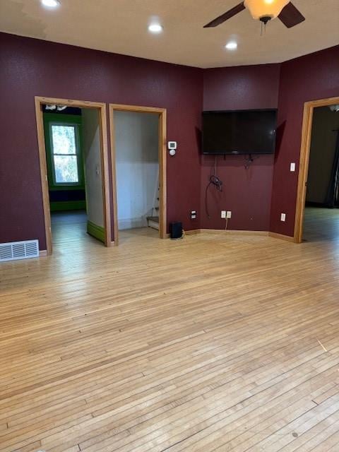 unfurnished living room with ceiling fan and light hardwood / wood-style floors