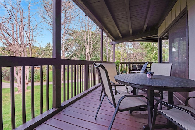 wooden deck with a lawn