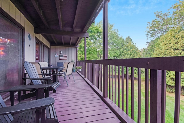 wooden terrace featuring a yard