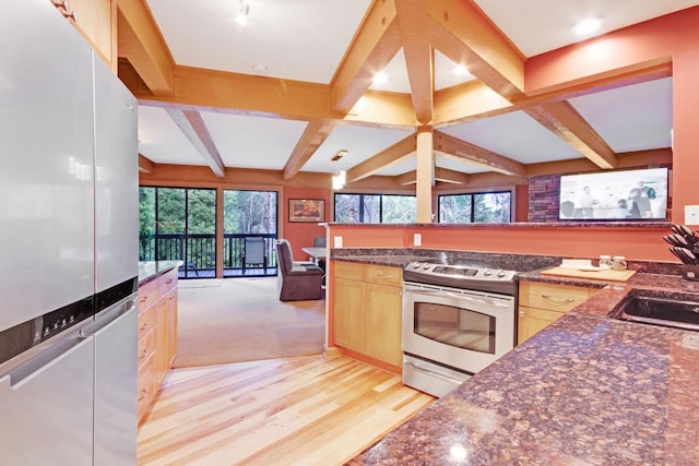 kitchen featuring light wood-type flooring, light brown cabinetry, beam ceiling, sink, and appliances with stainless steel finishes