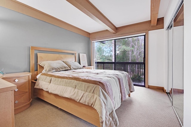 carpeted bedroom with access to exterior and beam ceiling