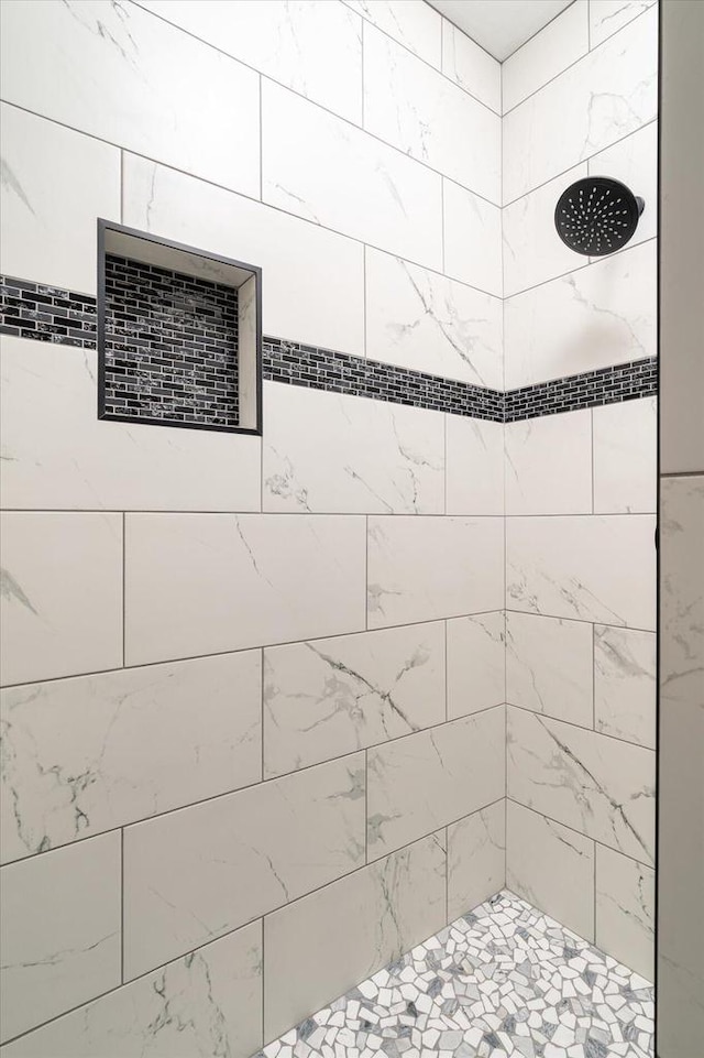 bathroom with tiled shower