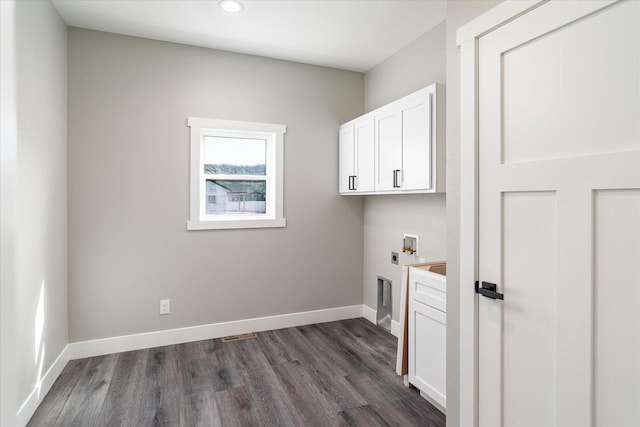 laundry area with washer hookup, cabinets, hookup for an electric dryer, and dark hardwood / wood-style flooring