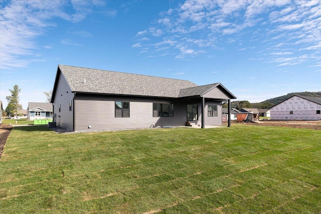 rear view of house with a lawn