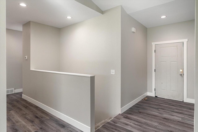 hallway with dark hardwood / wood-style flooring