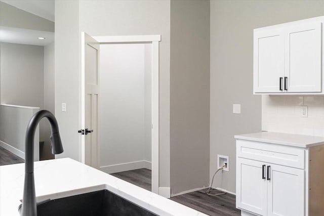 interior space with dark hardwood / wood-style floors and sink