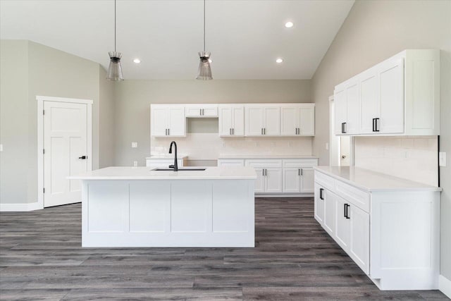 kitchen with decorative light fixtures, sink, decorative backsplash, dark hardwood / wood-style floors, and white cabinets