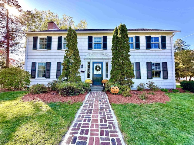 colonial inspired home with a front yard