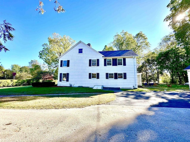 view of home's exterior with a lawn